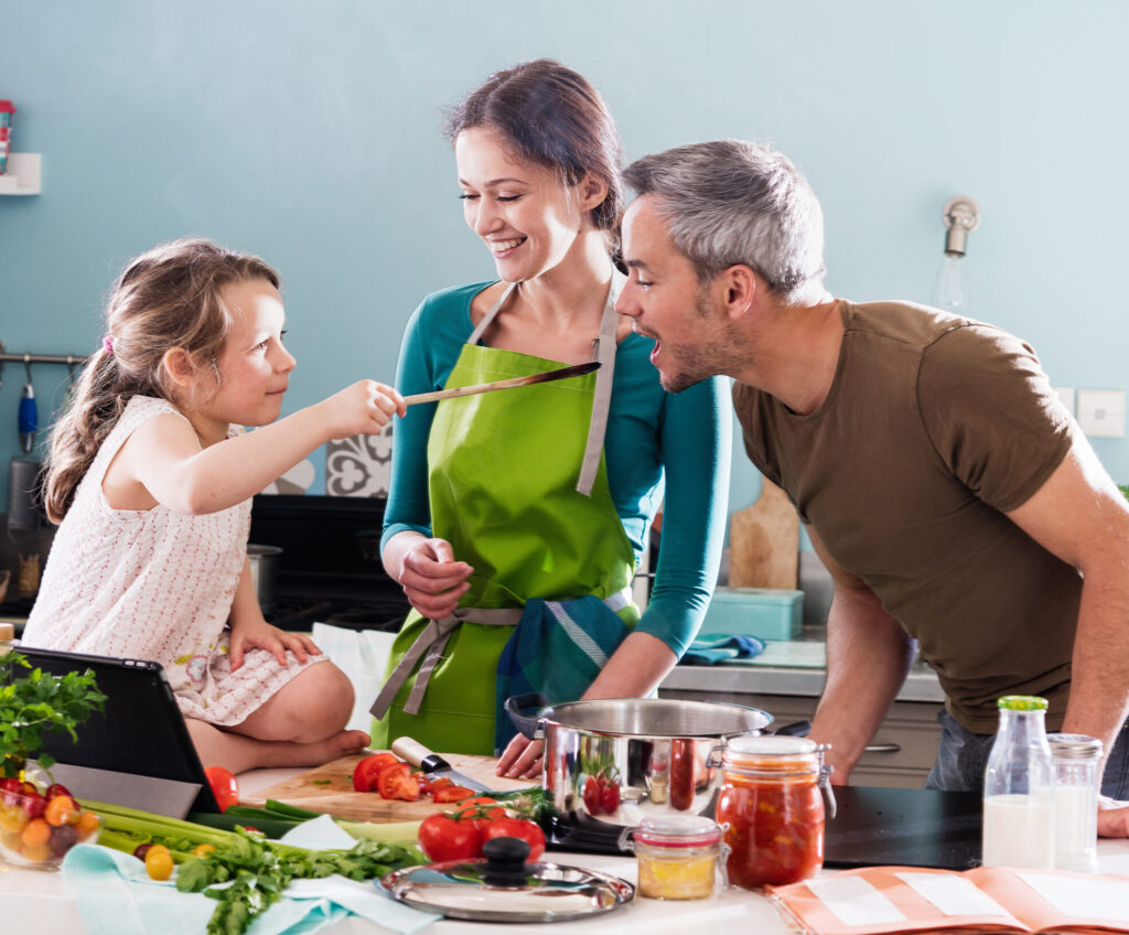 Happy family cooking healthy nutritious food